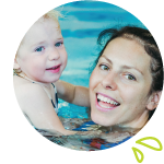Women and Child swimming, Wome holding child smiling facing forward.