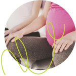 yoga class - pregnant lady sitting relaxed with hands on knees. 